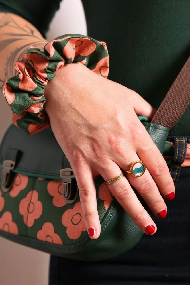 Gros plan sur le chouchou fleuri Pimprenelle porté au poignet, accessoire artisanal cousu main.